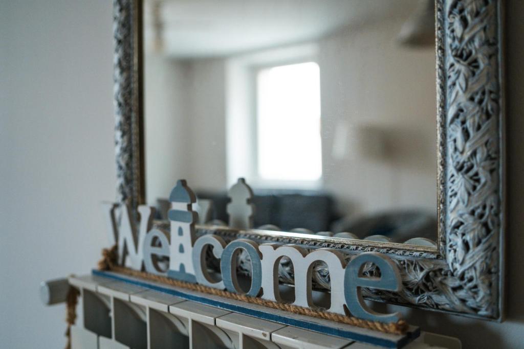 a mirror on a mantel in a living room at Hurban Apartments Muggia in Muggia