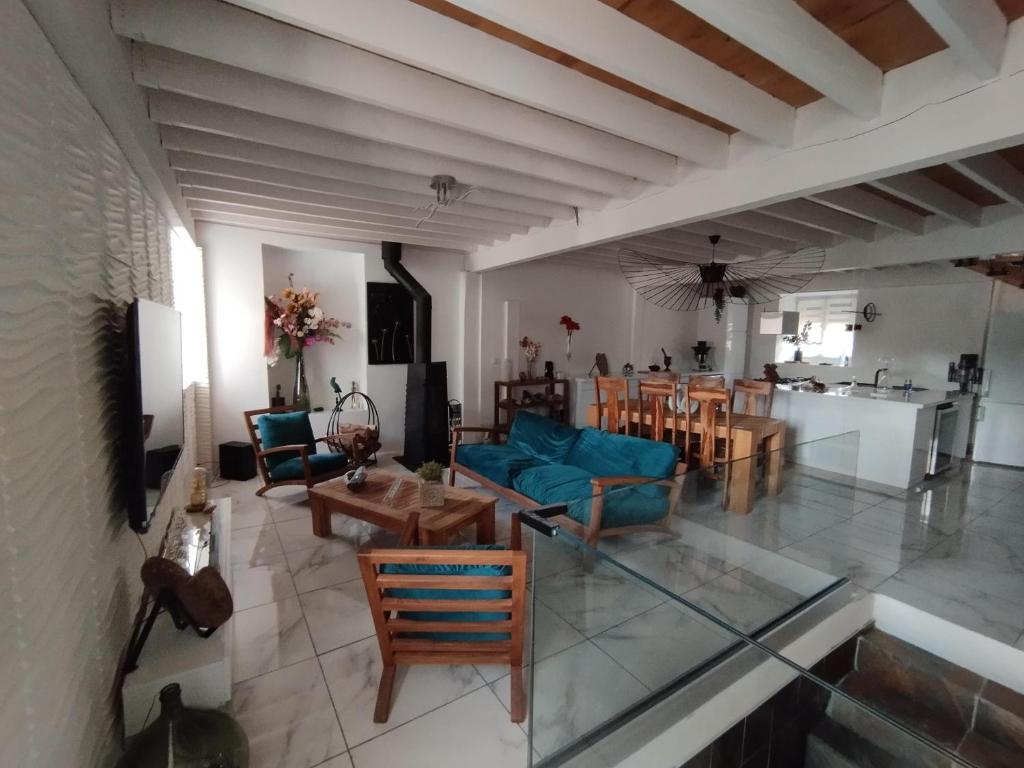 a living room with a blue couch and a table at CHEZ COCO in Roquefort-de-Sault