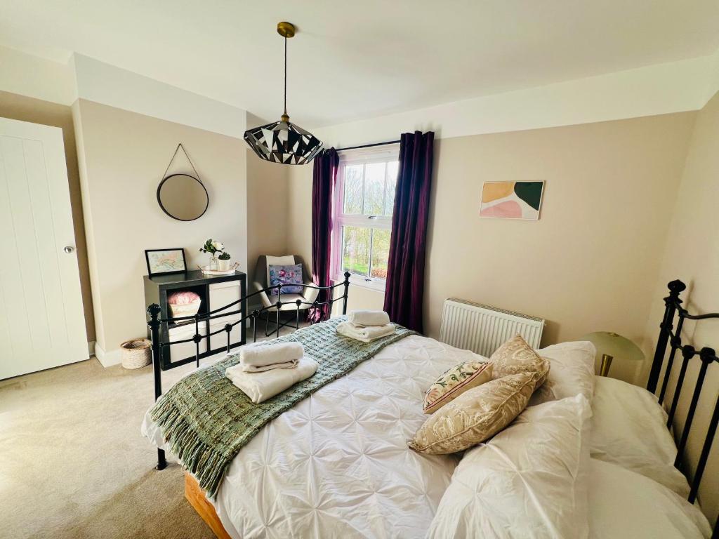 a bedroom with a bed with pillows on it at NEW homely countryside escape in Manningtree