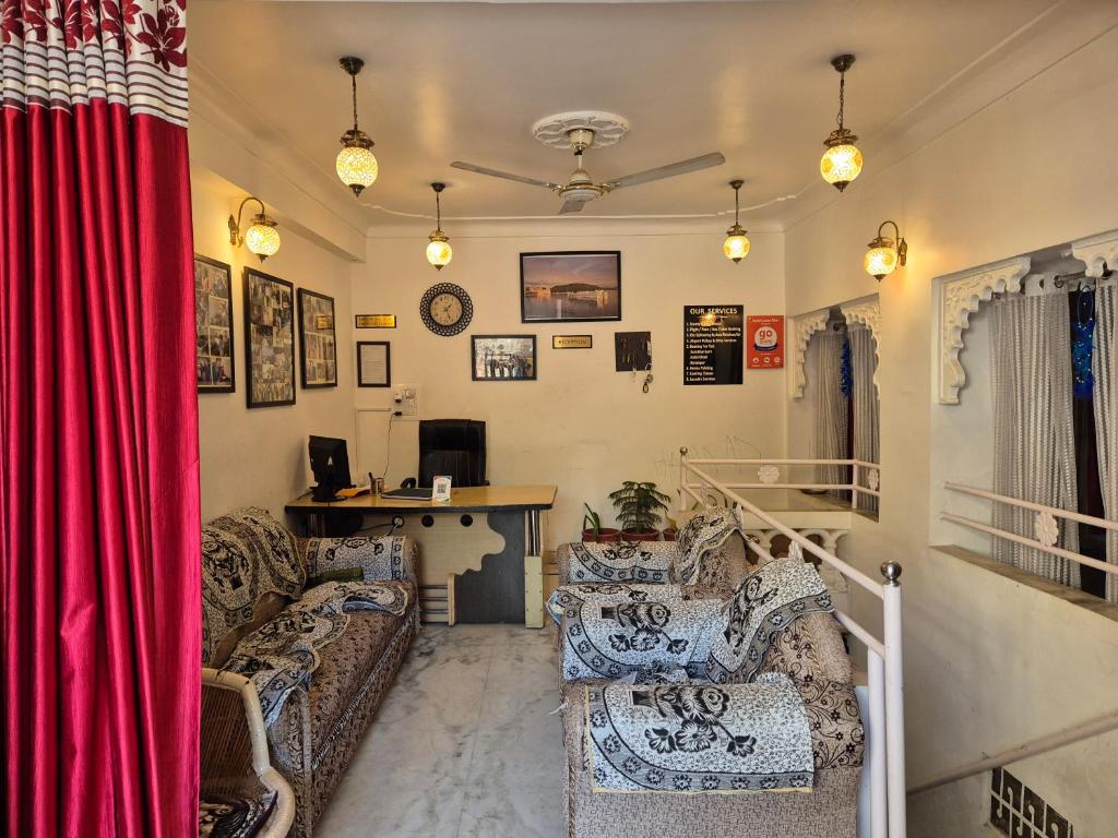 a living room with couches and a red curtain at Hotel Lake Star in Udaipur