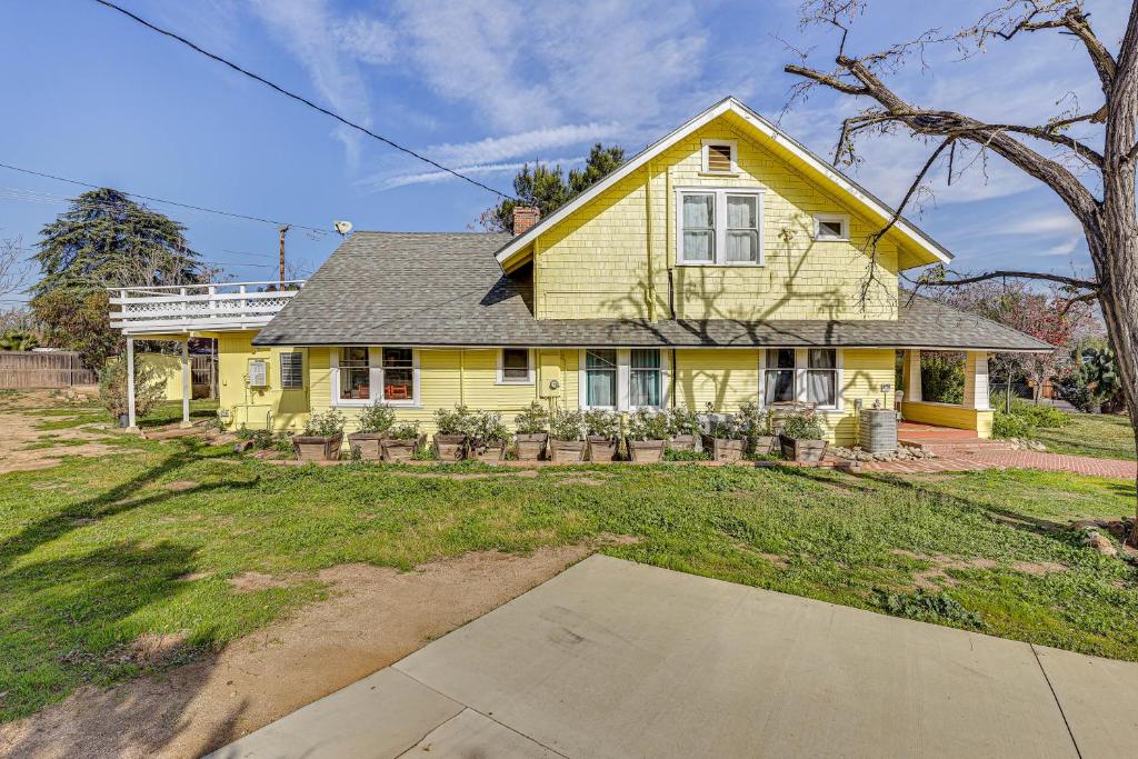 a yellow house with a driveway in front of it at Eclectic Wildomar Home 6 Mi to Santa Rosa Plateau in Wildomar