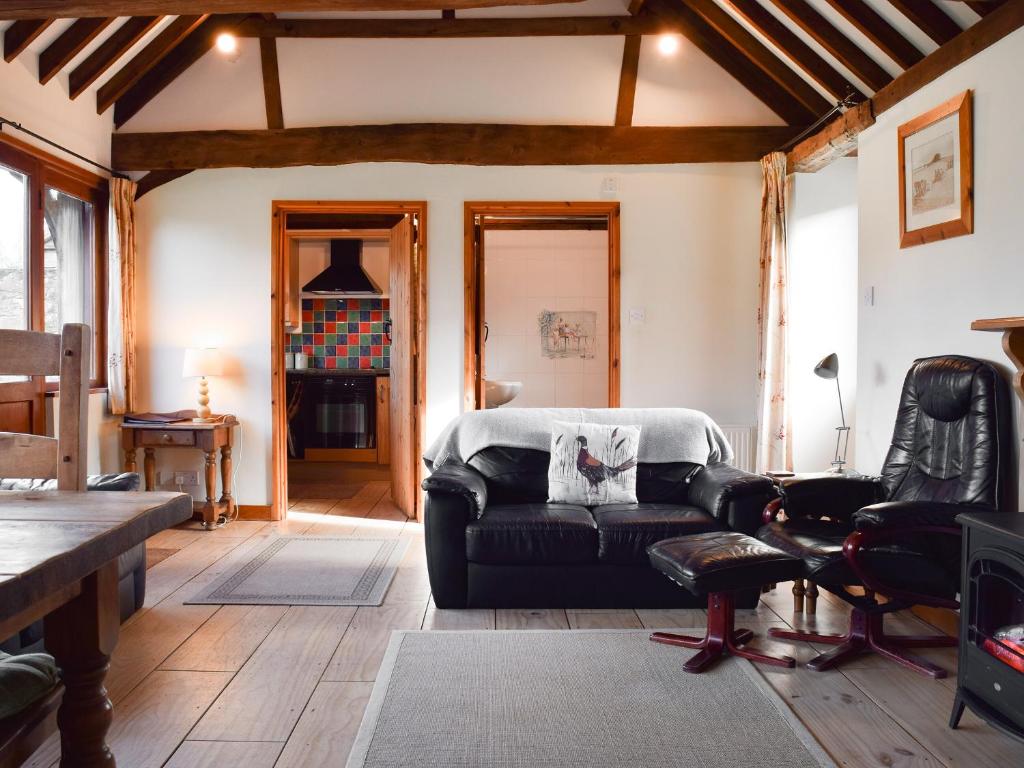 a living room with a couch and a table at The Old Dairy - Meadowbrook Farm in Thame