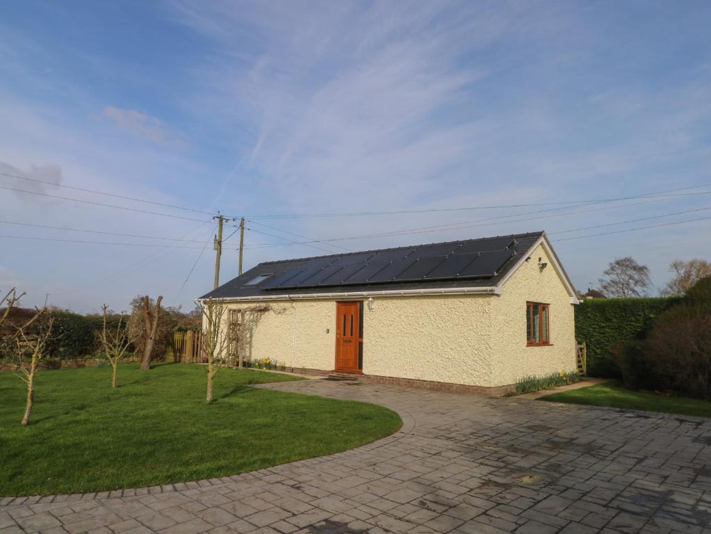 a house with a solar roof with a driveway at The Brambles in Wrexham