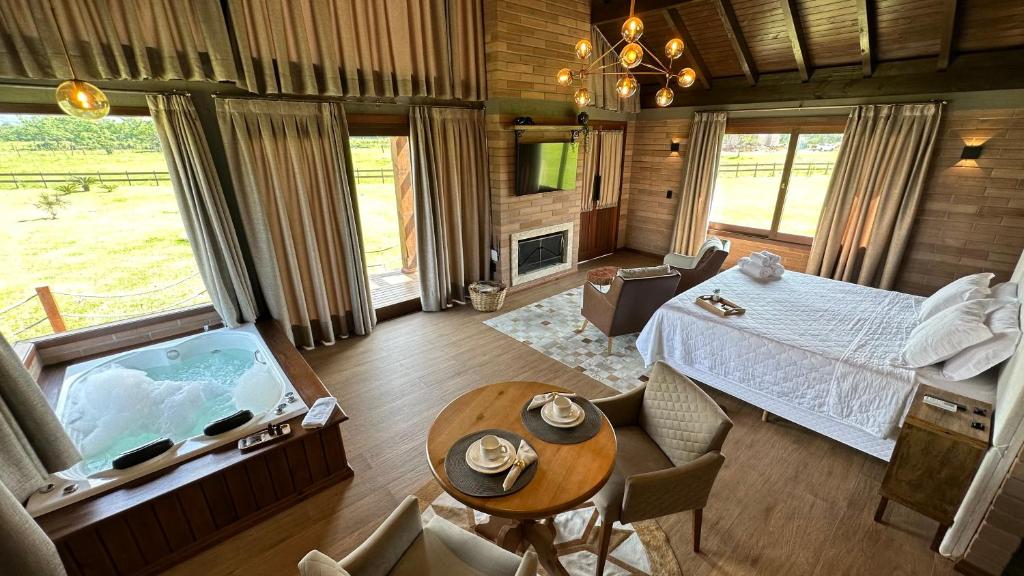 a bedroom with a bed and a tub in a room at Mirador da Montanha in Praia Grande