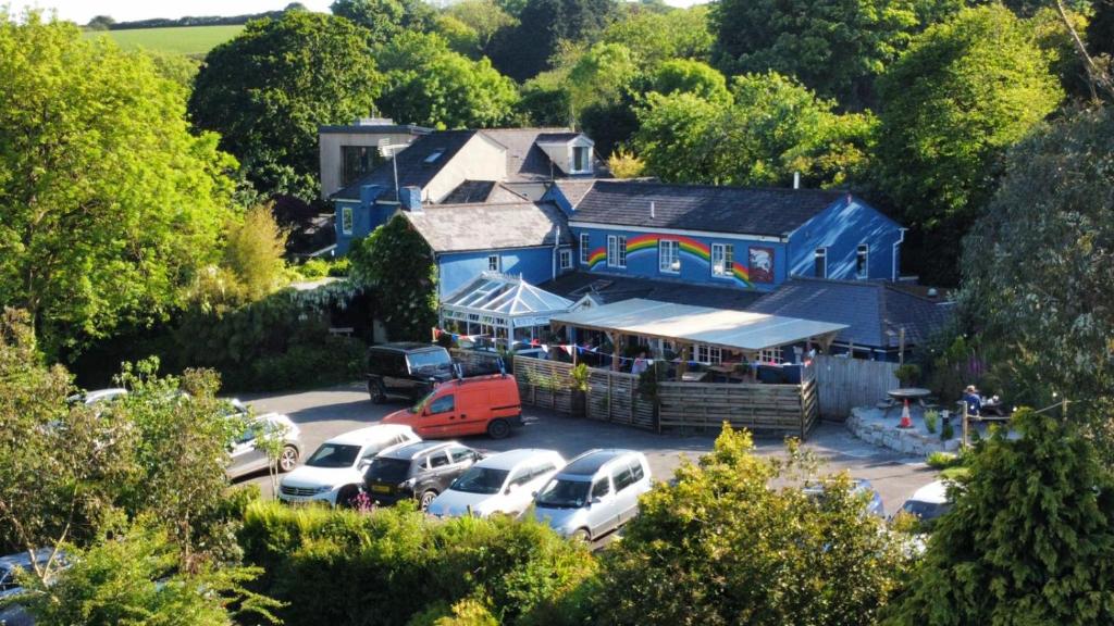 a blue building with cars parked in a parking lot at Trengilly Wartha Inn in Constantine