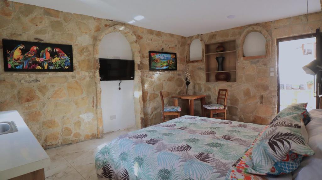 a bedroom with a bed and a tv on the wall at La Hacienda Cyprus in Limassol