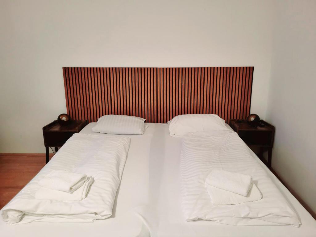 a large white bed with two pillows on it at Floridsdorfer Apartment - Free Highspeed-Internet in Vienna