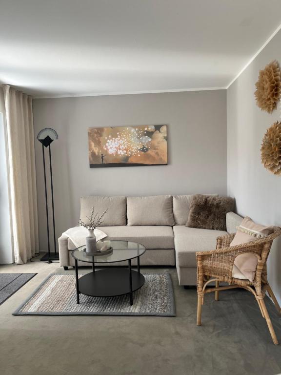 a living room with a couch and a table at Privatwohnung mit Terrasse zum Relaxen in Lennestadt