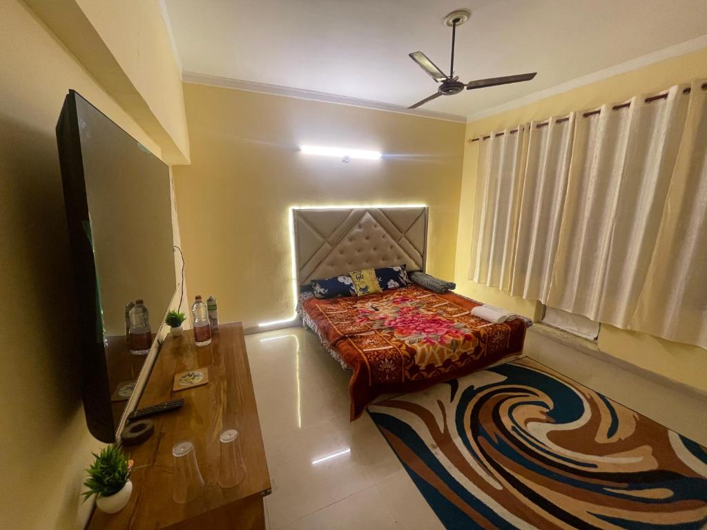 a bedroom with a bed and a flat screen tv at Silicon Valley in Lucknow