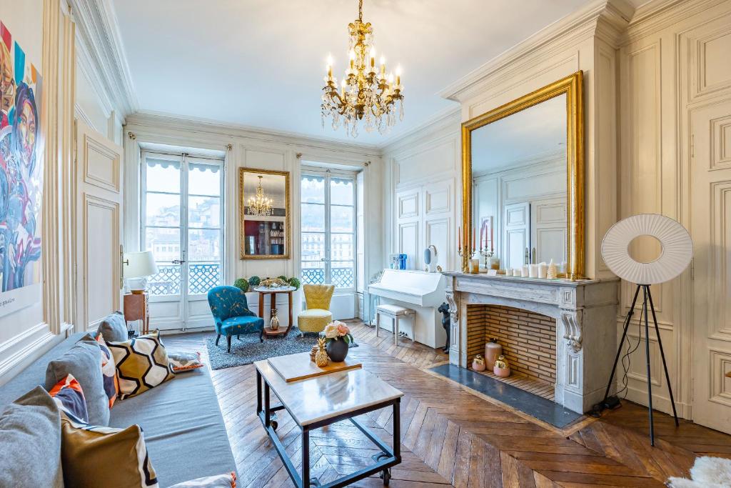 a living room with a fireplace and a mirror at Appartement Haussmannien d’Artiste, exception, quai de Saône balcon+Parking in Lyon