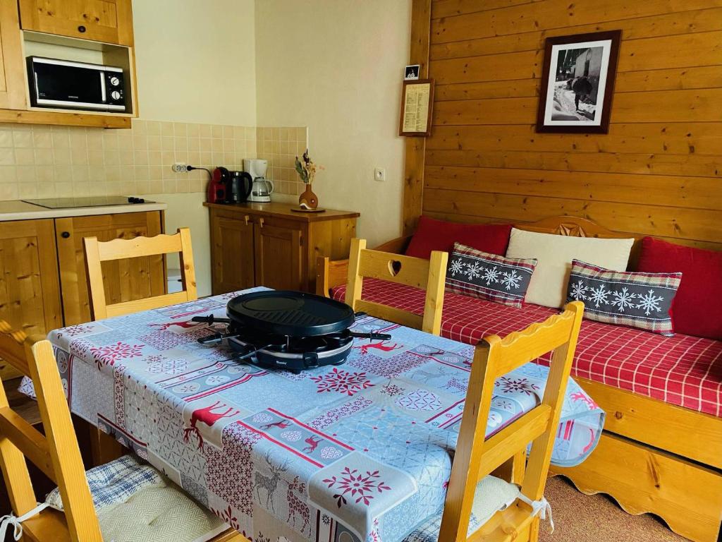 a kitchen with a table with a pot on it at Appartement Lanslebourg-Mont-Cenis, 2 pièces, 4 personnes - FR-1-508-186 in Lanslebourg-Mont-Cenis