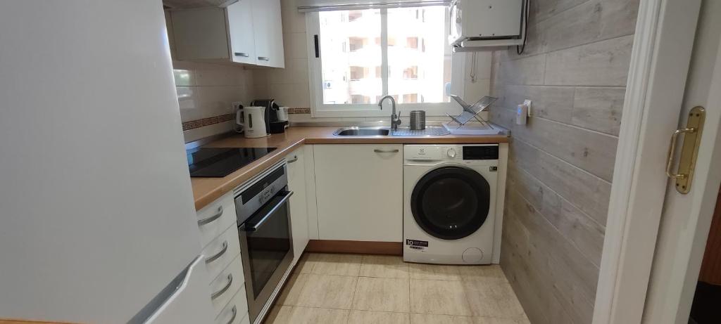 a kitchen with a washing machine and a sink at BEACH FOREST PARADISE in Cabopino