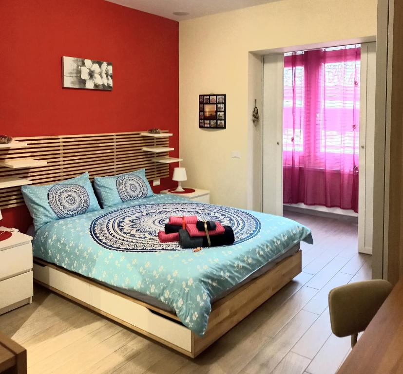 ein Schlafzimmer mit einem Bett mit einer roten Wand in der Unterkunft Lady D Bed&Breakfast in Rom