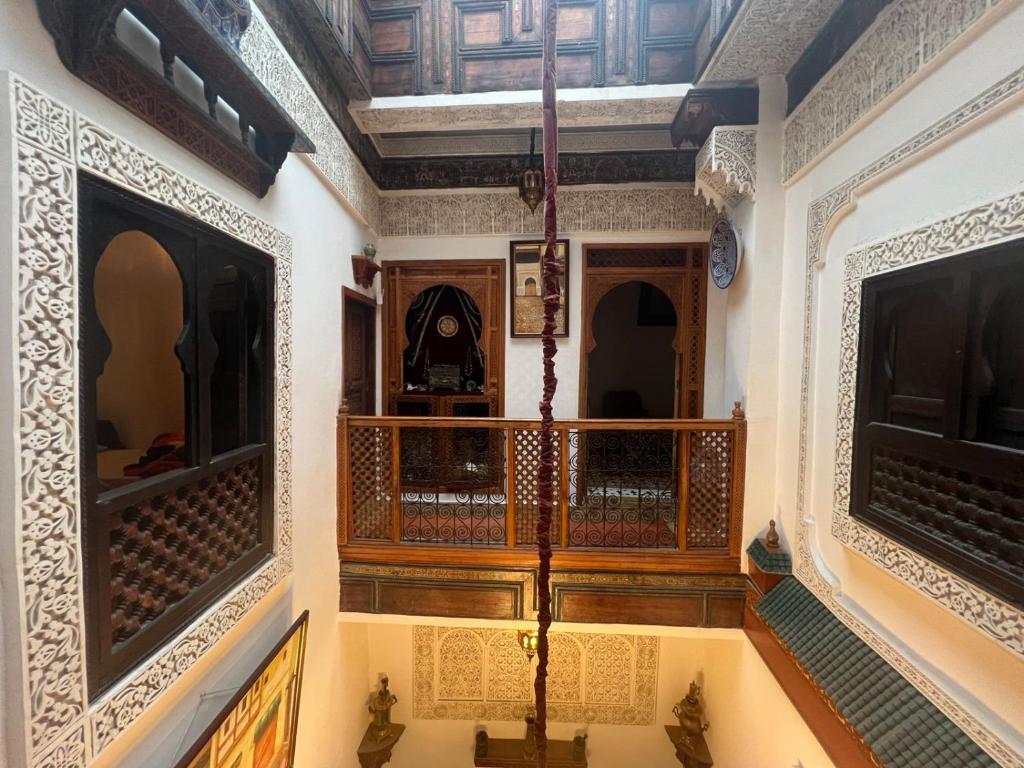 a hallway in a house with wooden walls and ceilings at Riad dar Kirami in Fès