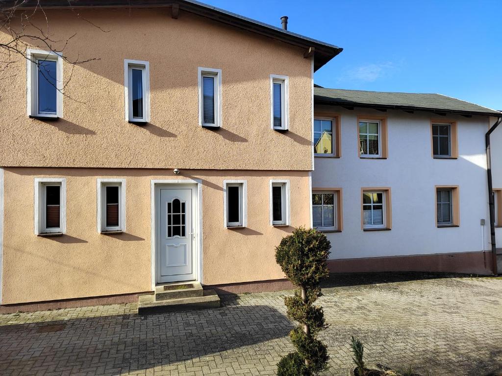ein Haus mit einer weißen Tür und einem Innenhof in der Unterkunft Haus Alva in Ahlbeck
