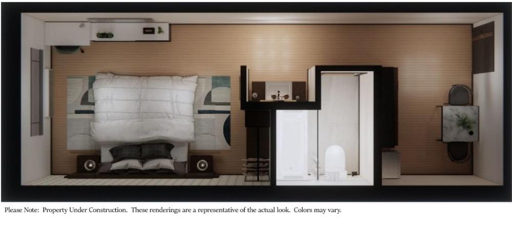 uma fotografia de um quarto com uma cama em eStudio Suites em Plainfield