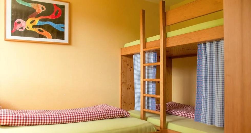 a bedroom with two bunk beds and a painting at Bio Ferienbauernhof Greber in Schwarzenberg