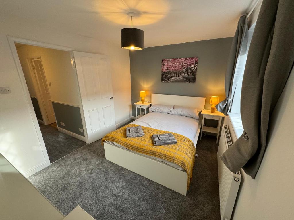 1 dormitorio pequeño con 1 cama y 2 lámparas en Cosy home with parking close to city centre, en Exeter