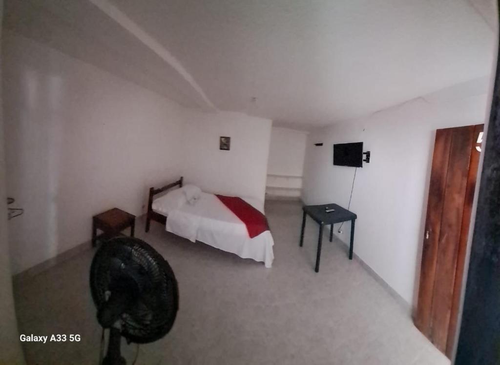 a bedroom with a bed and a tv in it at Alojamiento in Bahía Solano