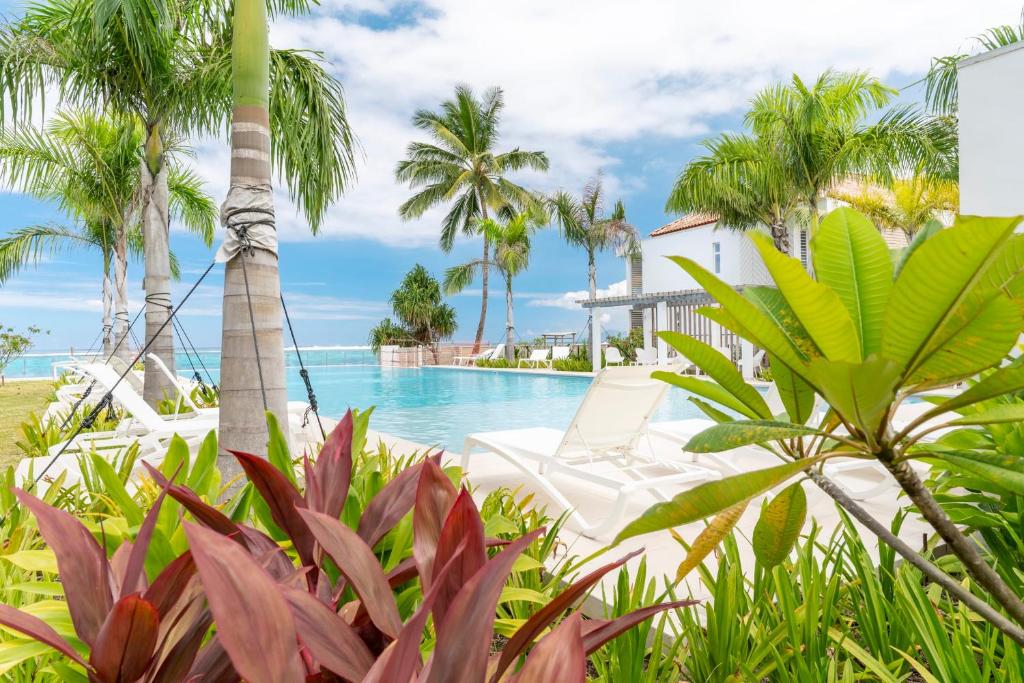 a resort with a pool and palm trees at Tropical paradise luxury in Paea