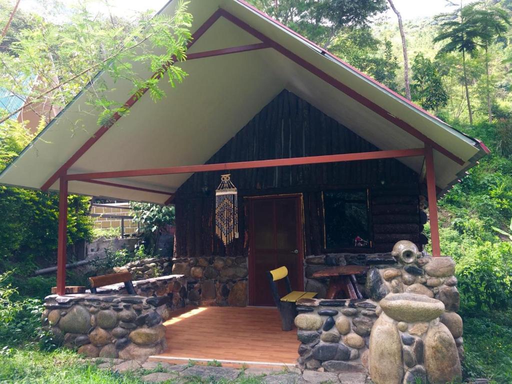 una cabina con terrazza in legno e tetto di Madera Verde Ecolodge a Maranura