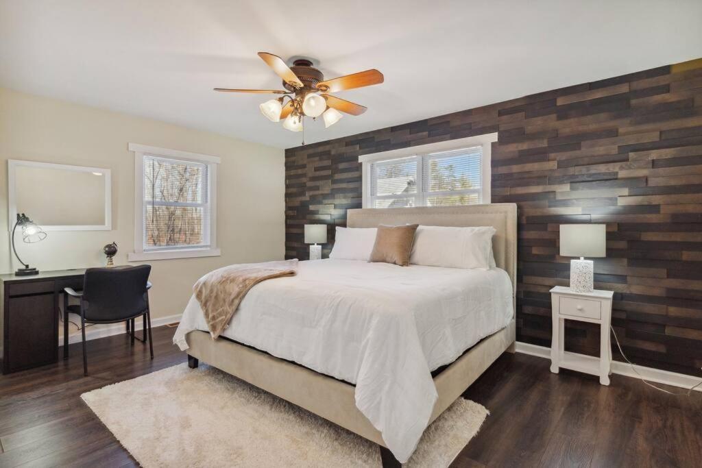 a bedroom with a bed and a ceiling fan at Valley Vista-Mins to SkylineDrive-Hot Tub-King, Queen Beds in Front Royal