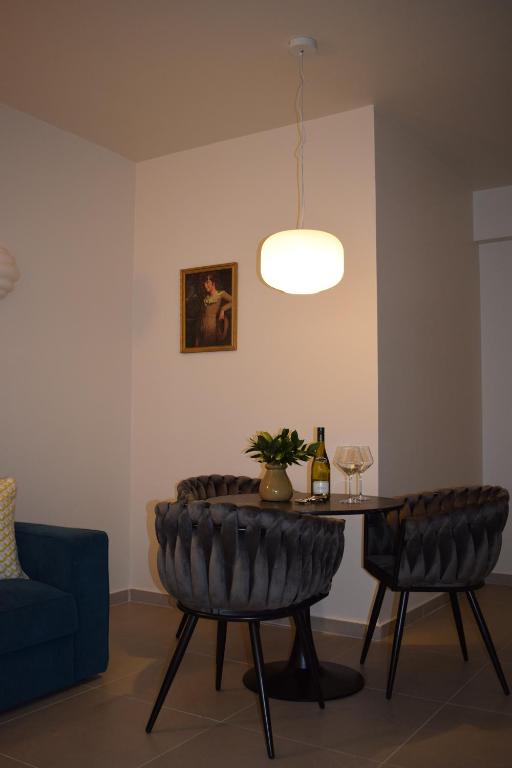sala de estar con mesa y sofá azul en T&L Apartments Agiaos Tychonas, en Limassol