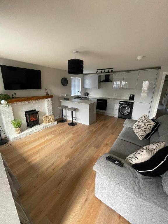 a living room with a couch and a fireplace at Luxurious apartment Gilnahirk in Belfast