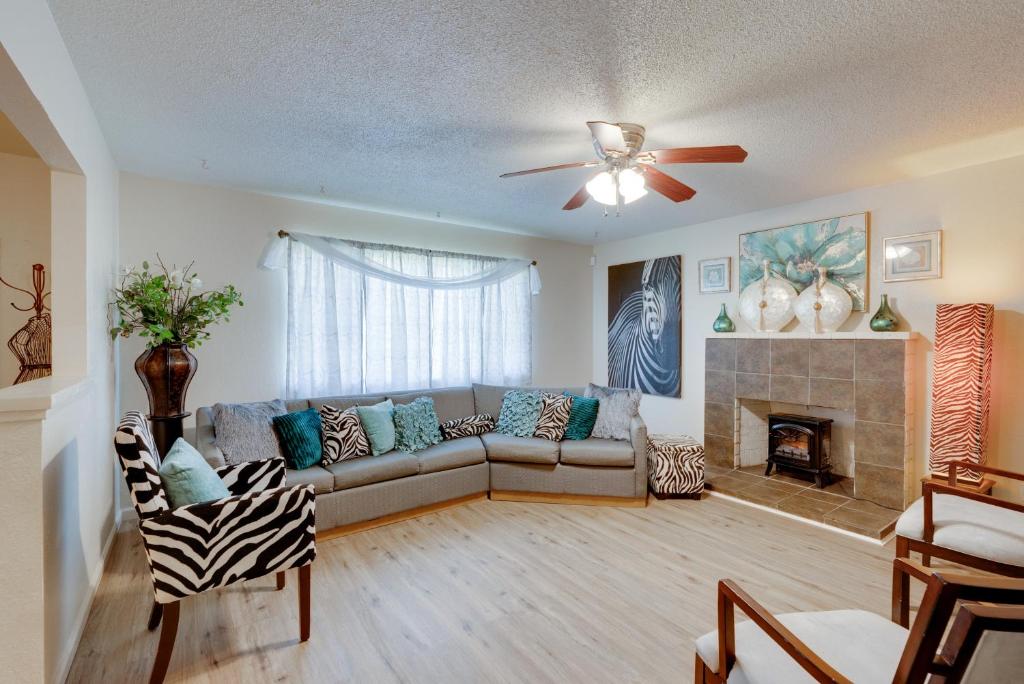 a living room with a couch and a fireplace at Breezy Fresno Home - Near Airport and Downtown in Fresno