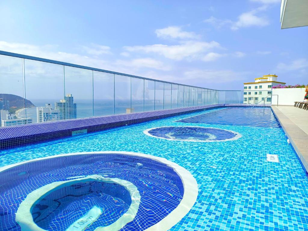 a swimming pool on the roof of a building at Exclusivos apartasuites Ambar Roca - Rodadero in Santa Marta