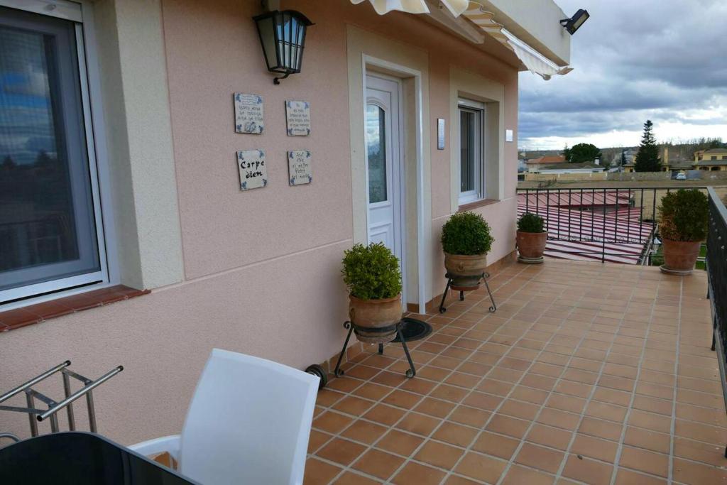 a patio with chairs and plants on a house at 2 bedrooms chalet with private pool terrace and wifi at Villamayor in Villamayor