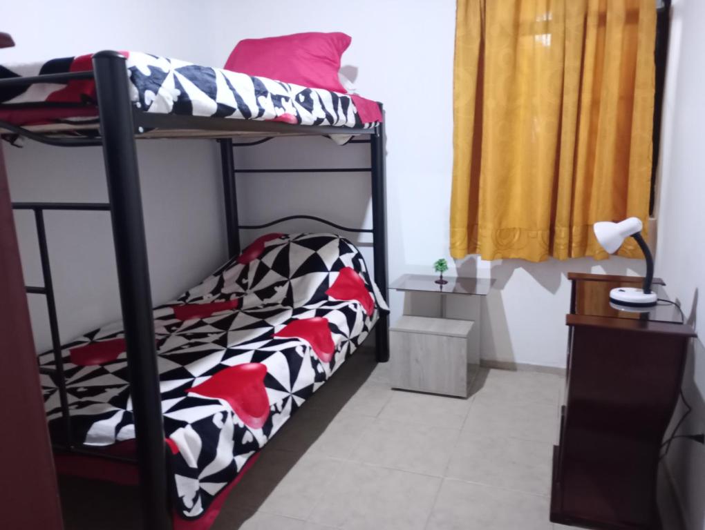 a bedroom with two bunk beds and a desk at Apartamento Centro histórico in Bogotá