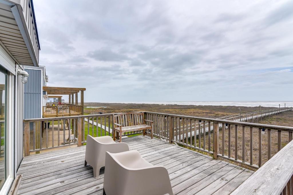 a deck with chairs and tables on a house at Wake Up to Waves | Oceanfront Surfside home in Surfside Beach