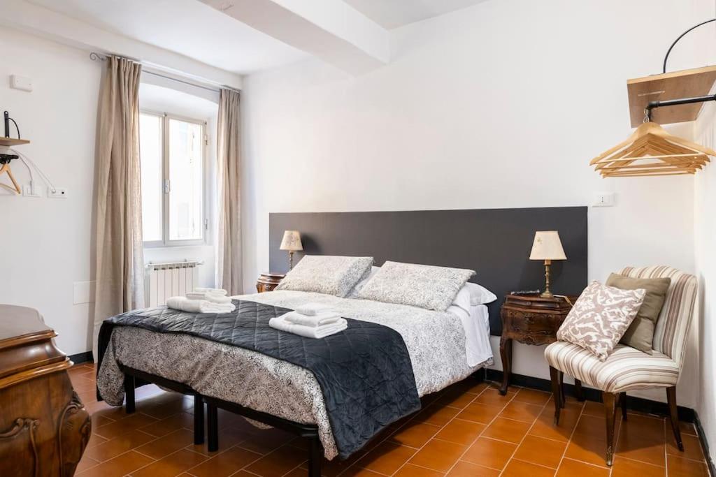 a bedroom with a large bed and a chair at Centro Storico di Genova a 15 minuti, Sweet Home in Genoa