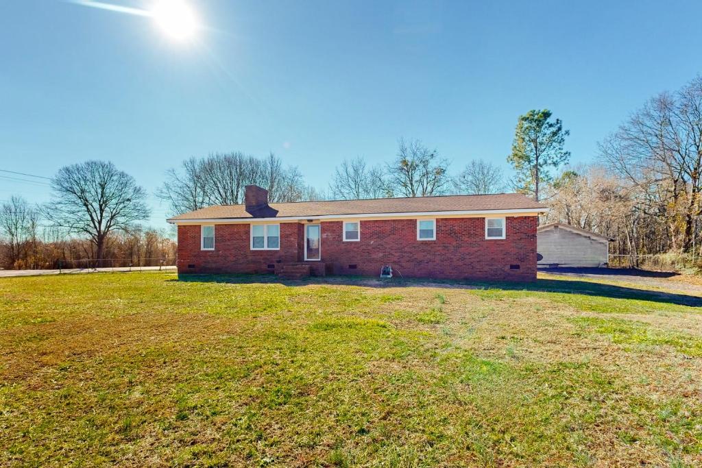 a red brick house with a large yard at Getaway on Gossett in Spartanburg