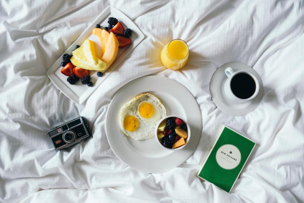 a breakfast plate of eggs and fruit and a cup of coffee at Loews New Orleans Hotel in New Orleans