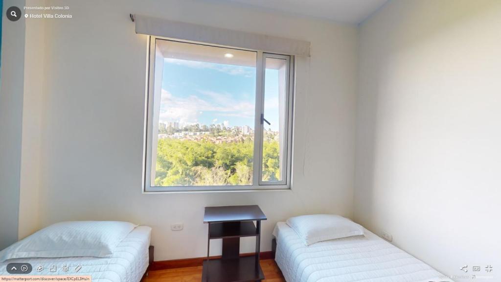 Postel nebo postele na pokoji v ubytování Hotel Villa Colonia