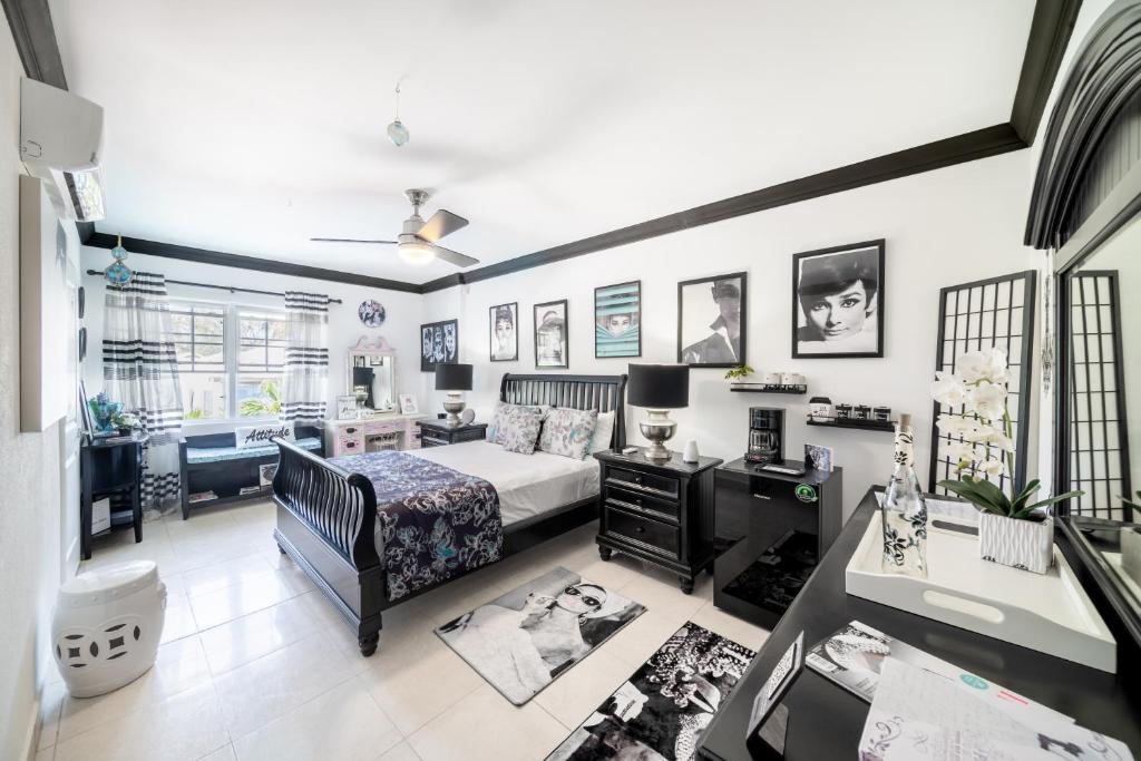 a bedroom with a bed and a desk in a room at Hidden Gem Barbados in Christ Church