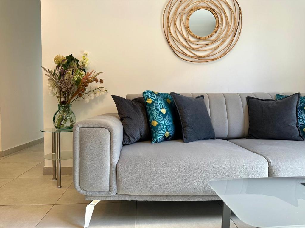 a living room with a couch and a vase with flowers at P&P - Brand new chic apartments in Athens