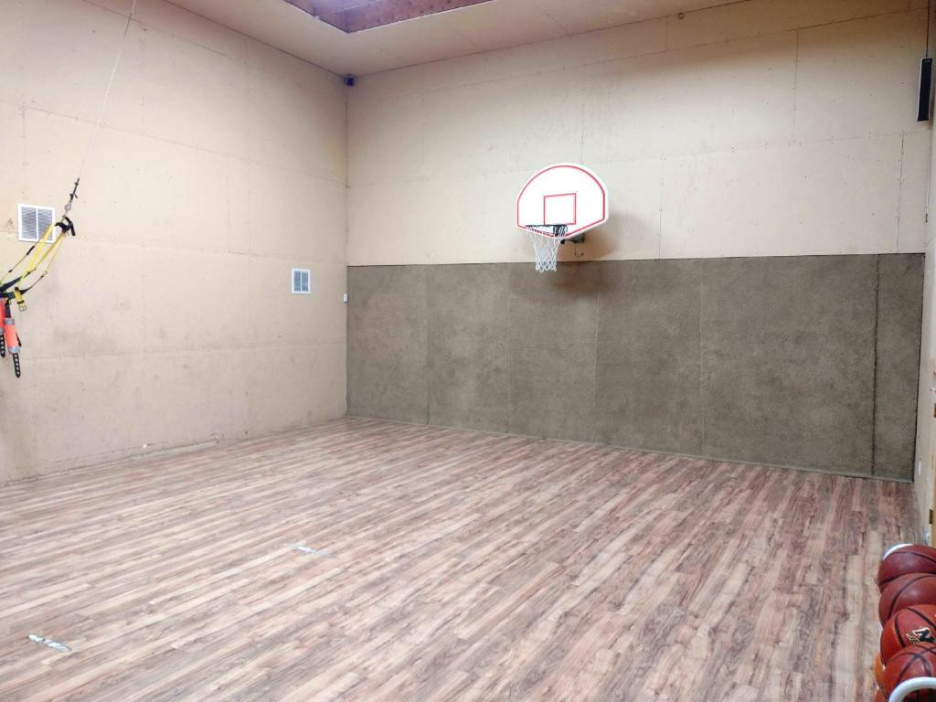 an empty gym with a basketball hoop on the wall at 4B Miracle Lodge - Stay&Play Together-Events/Reunions/Staycation/Ski in South Jordan