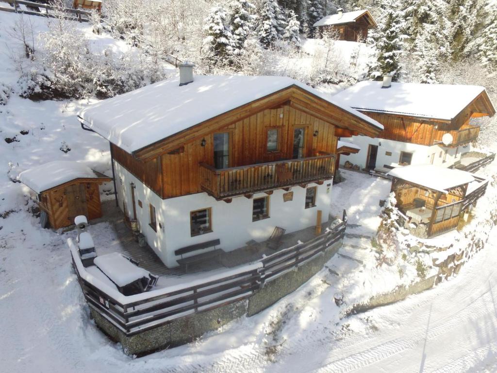 a large wooden house with snow on the roof at Chalet Emely in Piesendorf