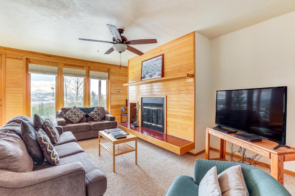 a living room with a large flat screen tv and a couch at Mtn-View Gem with Community Perks in Silverthorne! in Silverthorne