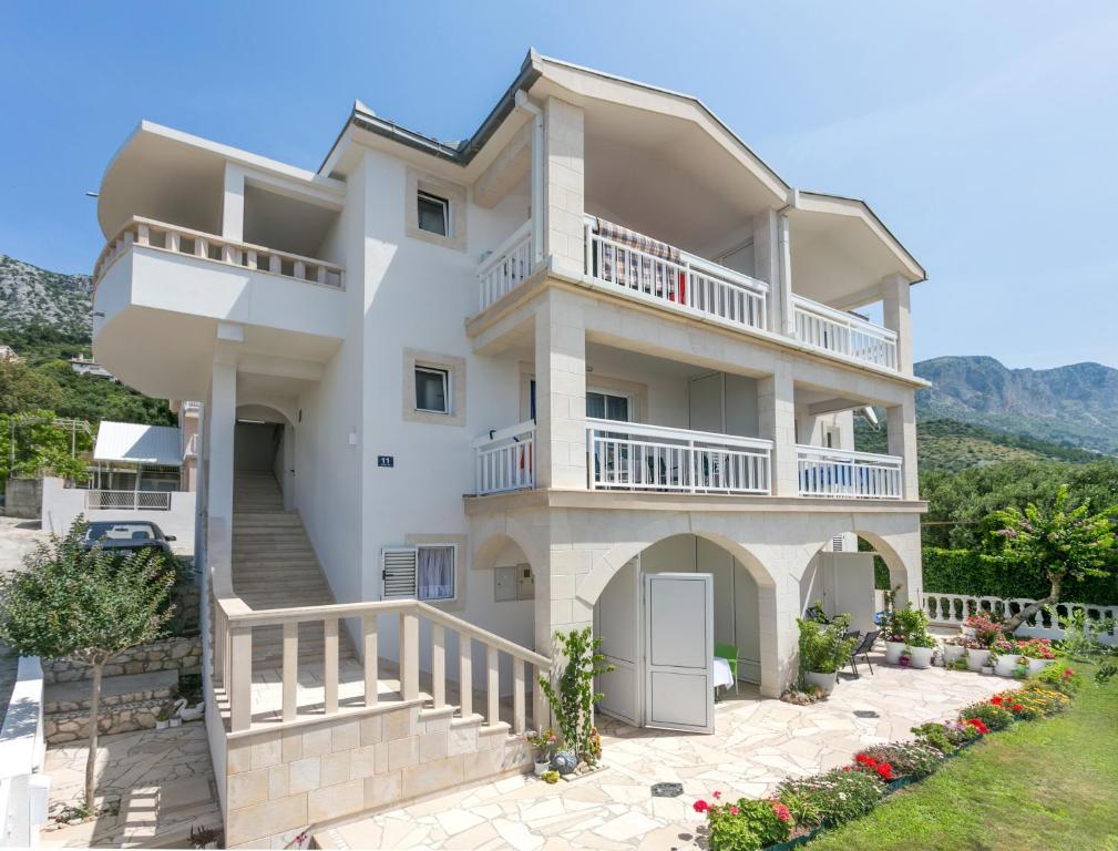 a large white house with a balcony at Studio Podaca 6736b in Podaca