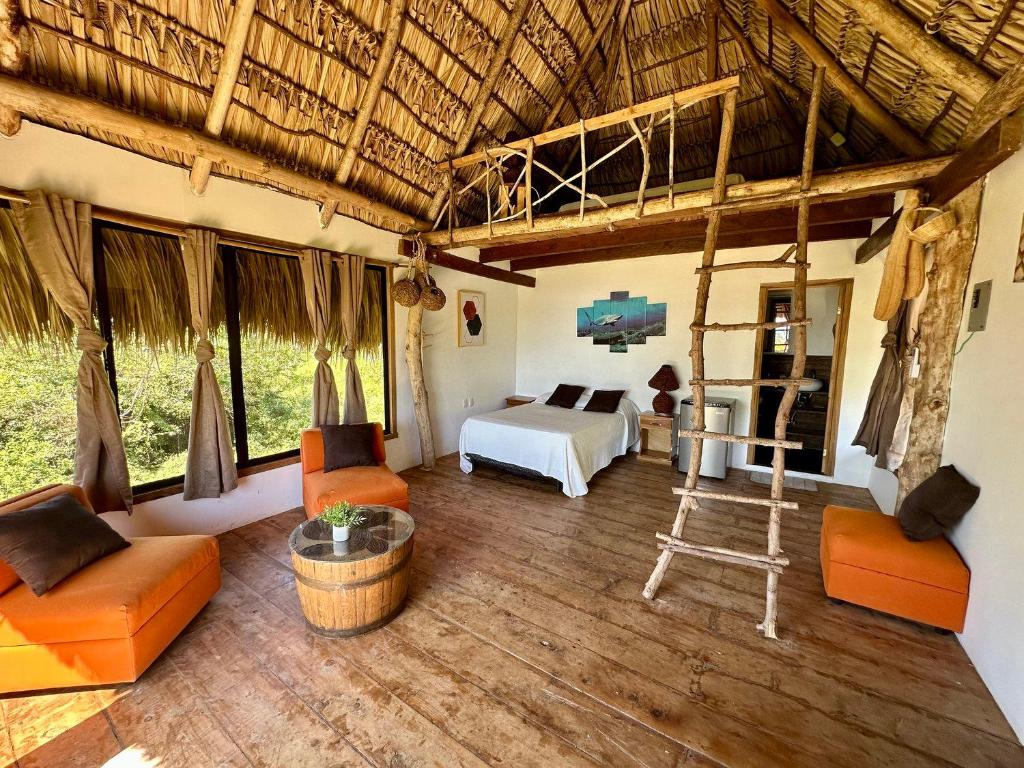 a room with a bed and a bed and a bedroom at Miravalle Eco Surf in Sonsonate