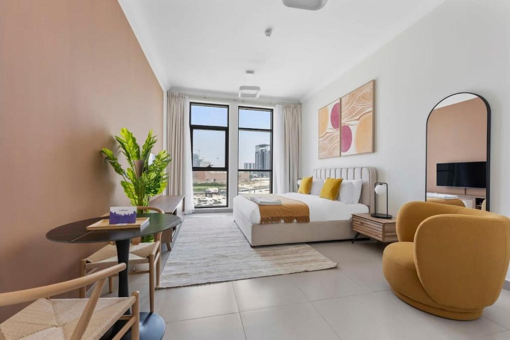 1 dormitorio con 1 cama extragrande y sala de estar en Silkhaus exquisite studio in Art Gardens with gym access, en Dubái