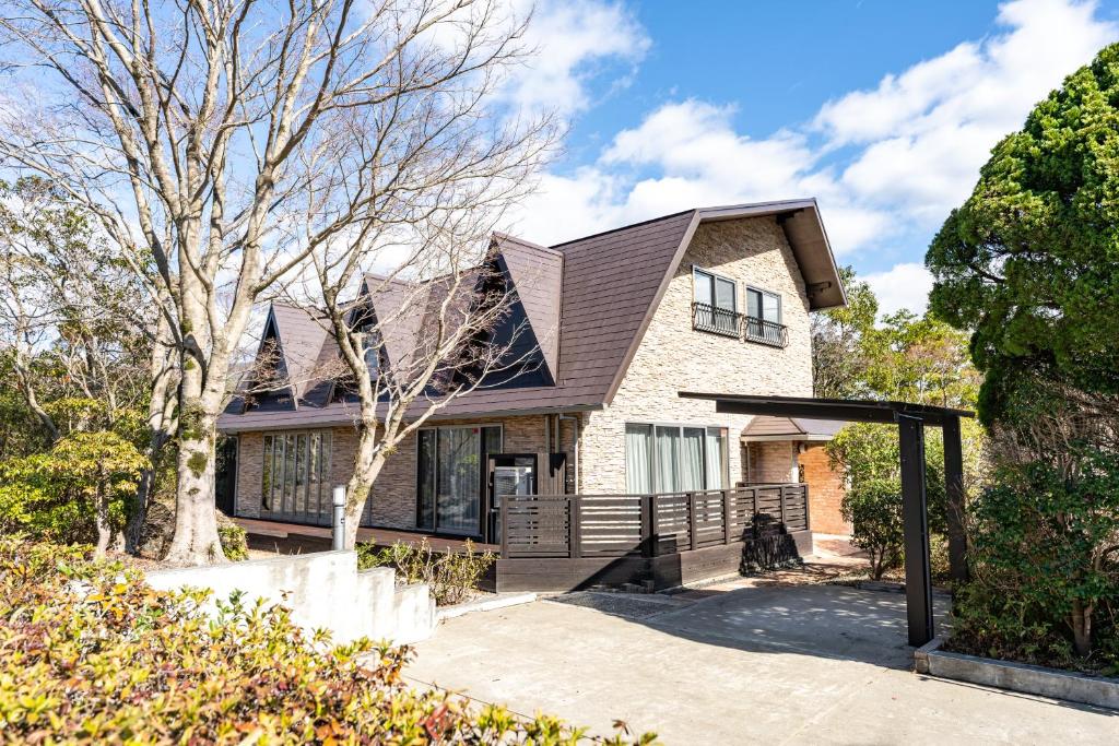 a house with a gambrel roof at 完全貸切別荘 天然温泉 La Saison inn Kirishima 888 in Kirishima