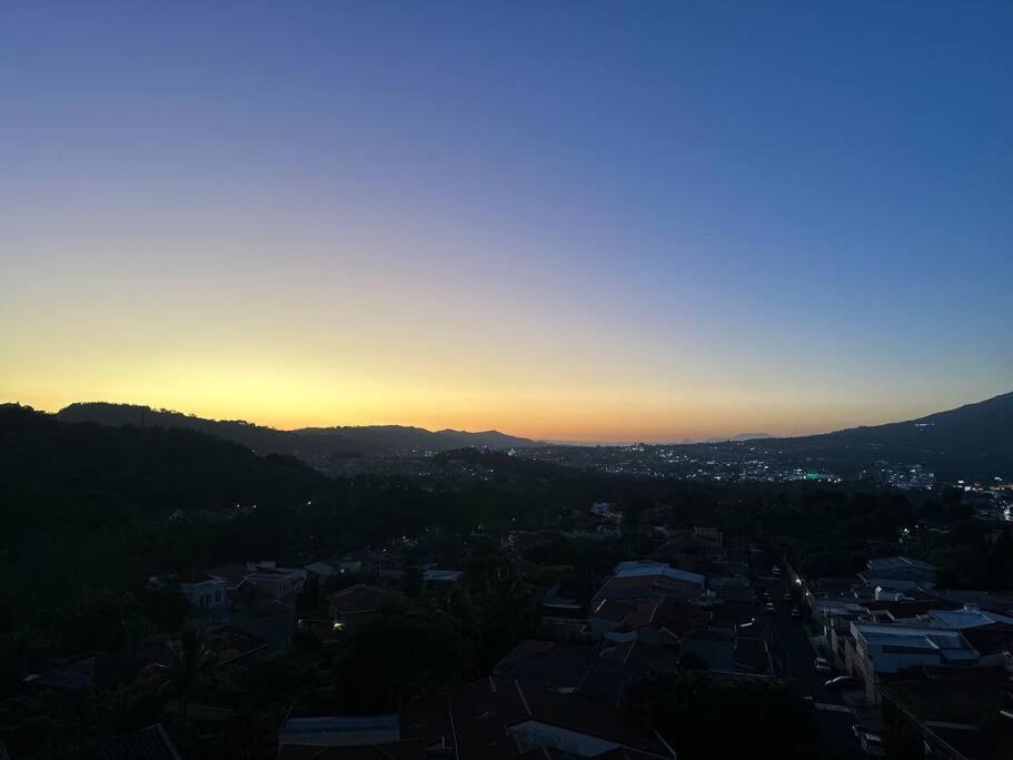 a view of a city with the sunset in the background at Sunset 302 in Antiguo Cuscatlán