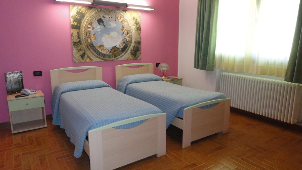Postel nebo postele na pokoji v ubytování Albergo Ristorante Fratte