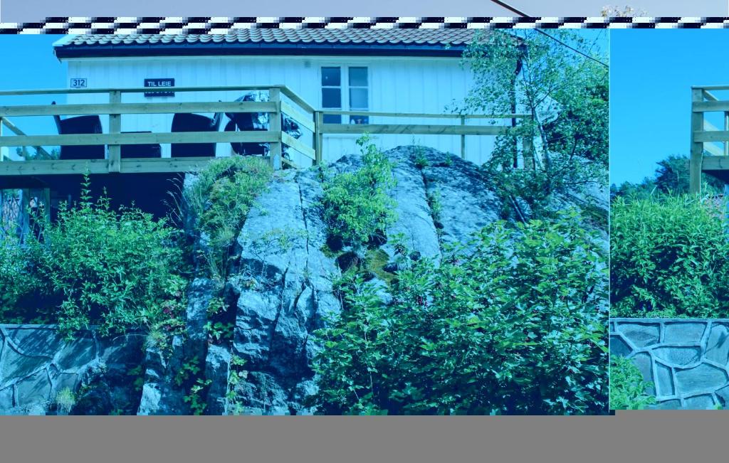 a house on top of a mountain with a bridge at Amazing Home In Staub With 1 Bedrooms And Wifi in Staubø