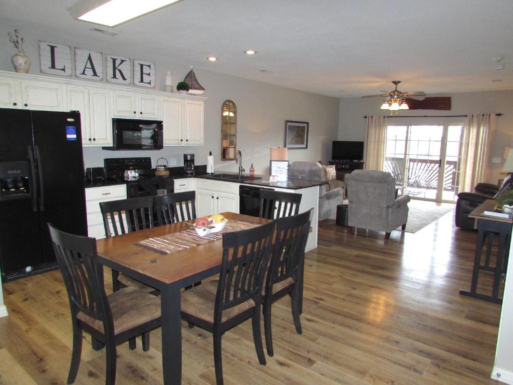 a kitchen and living room with a table and chairs at Walk-in level Condo B-6 Near Lake in Hollister